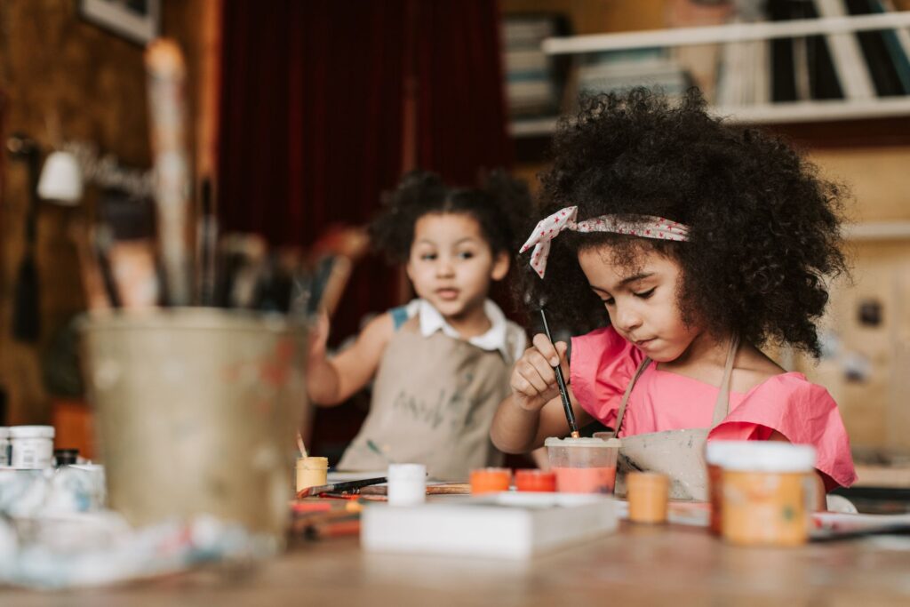 Young children experiment with paints.